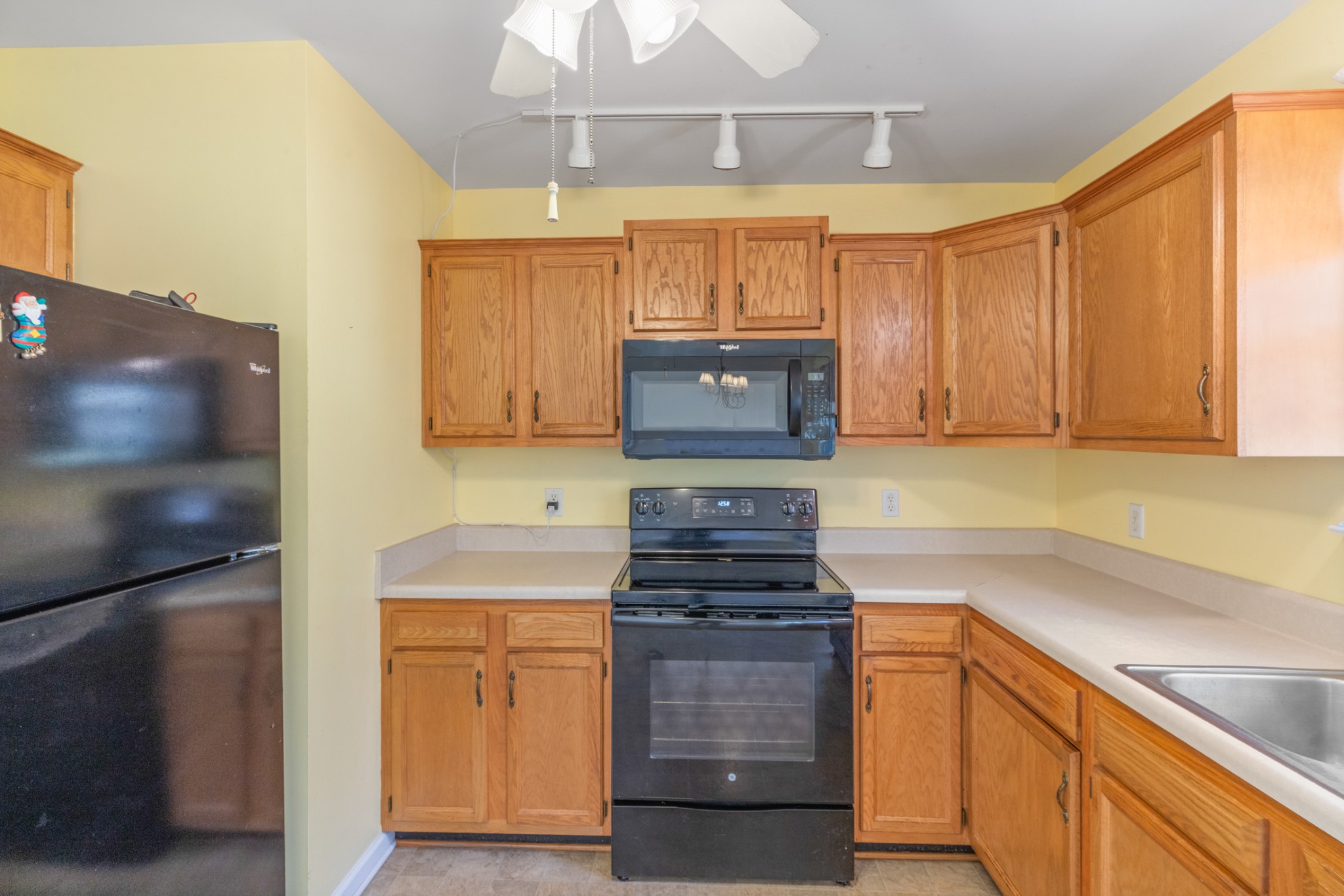 101 Garden View Court Dickson, TN 37055 - Photo 24 of 33 a kitchen with granite countertop white cabinets and stainless steel appliances