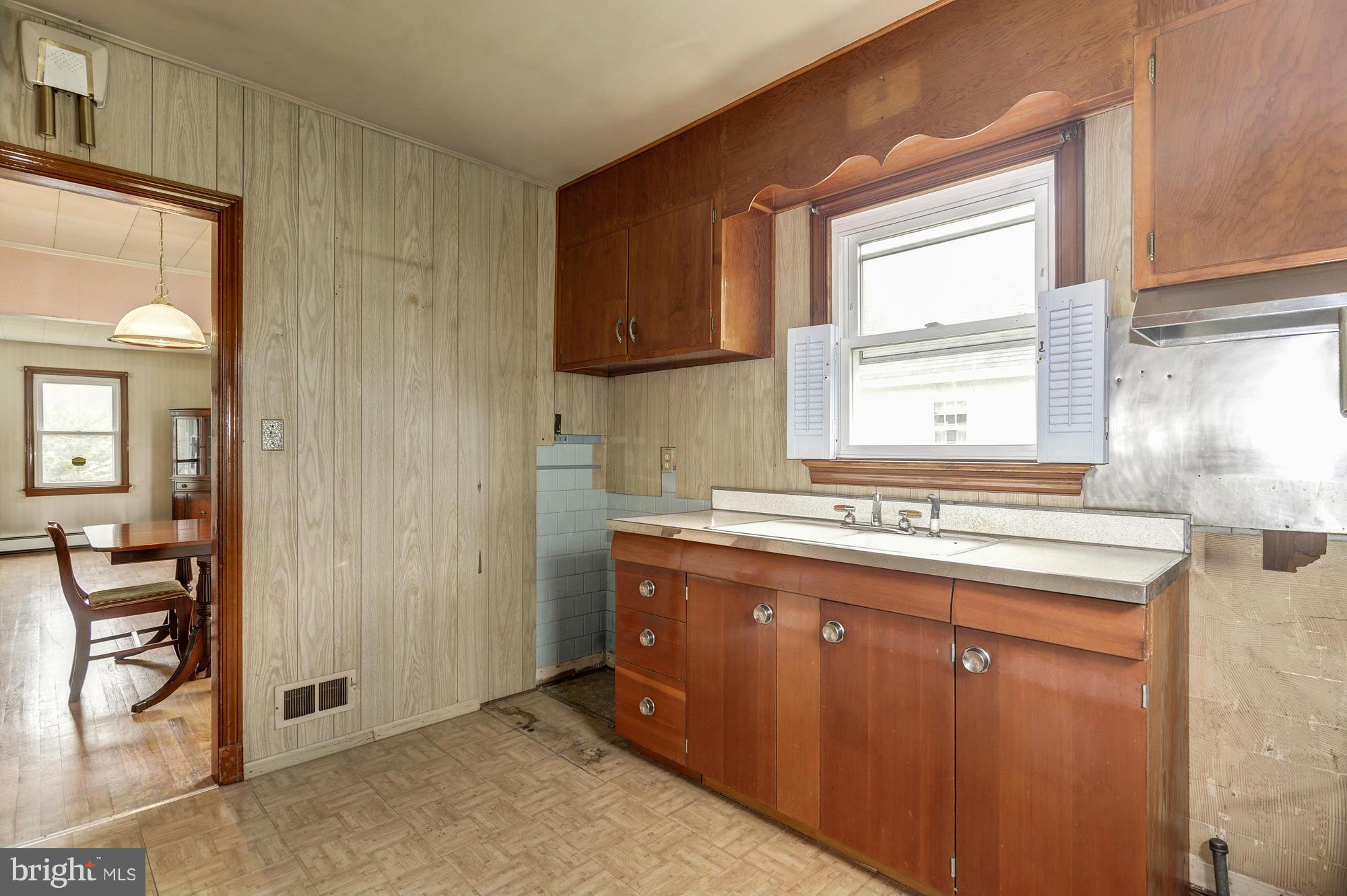 307 Charles Road Linthicum, MD 21090 - Photo 8 of 30 a kitchen with granite countertop a sink cabinets and window