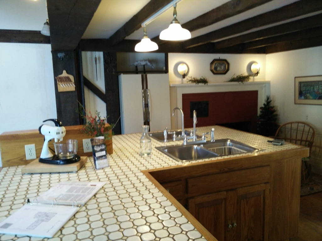 331 South Main Street Andover, MA 01810 - Photo 4 of 6 a living room with furniture and a fireplace