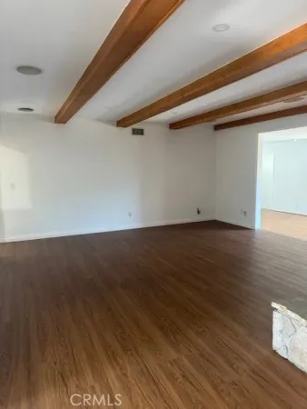 an empty room with wooden floor