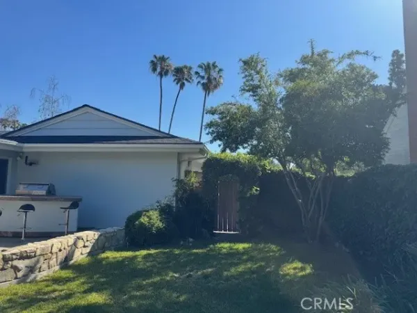 a backyard of a house with table and chairs