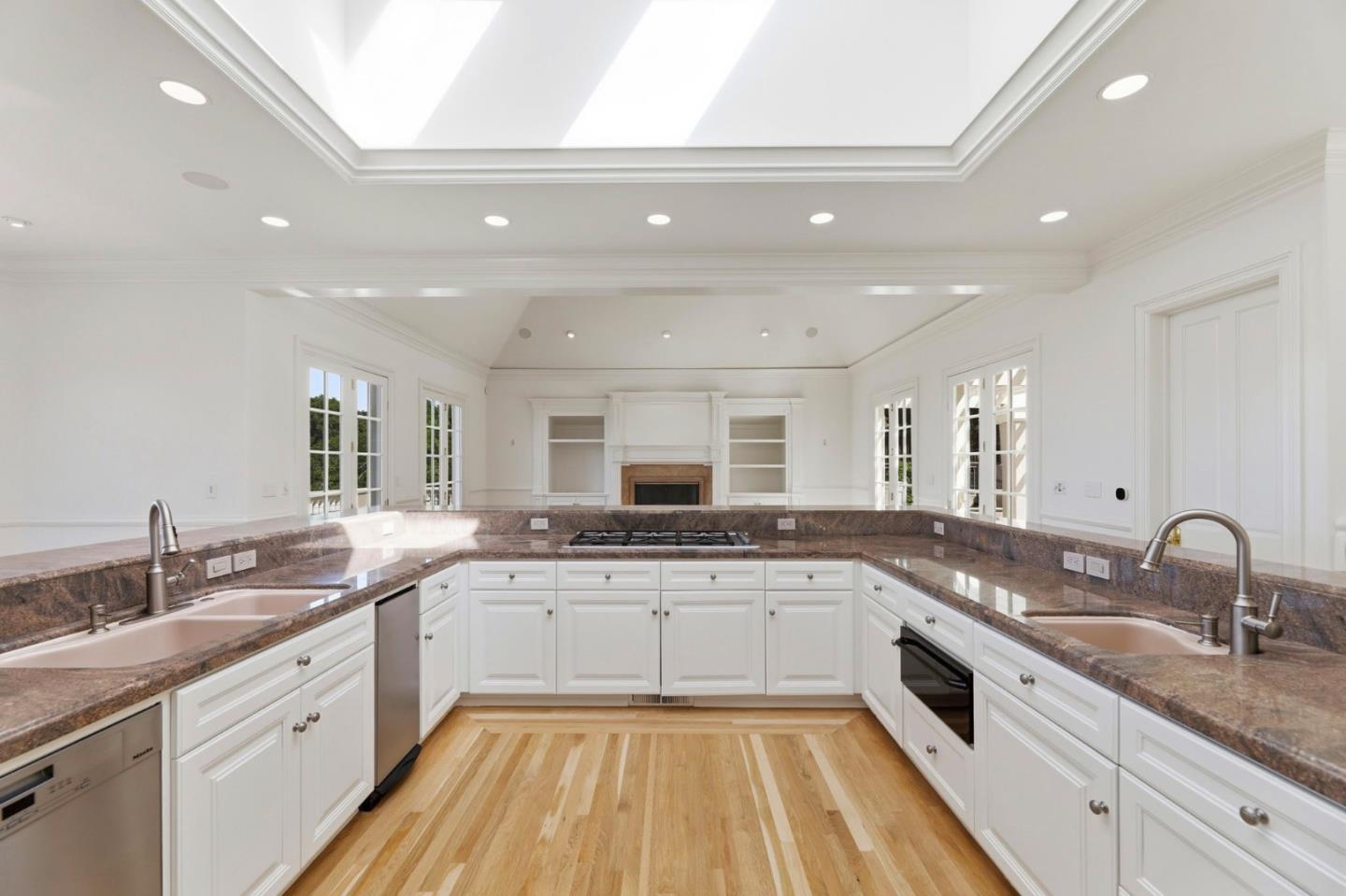 14113 Pike Road Saratoga, CA 95070 - Photo 21 of 78 a large kitchen with a sink and white cabinets