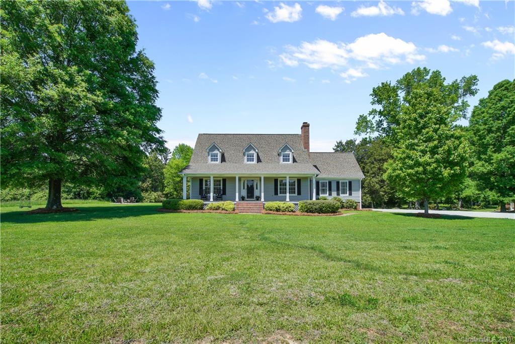 9049 Stacy Howie Road Indian Land, SC 29707 - Photo 2 of 36 a view of a big house with a big yard and large trees