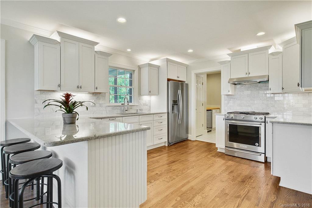 9049 Stacy Howie Road Indian Land, SC 29707 - Photo 11 of 36 a kitchen with kitchen island a sink stainless steel appliances and cabinets
