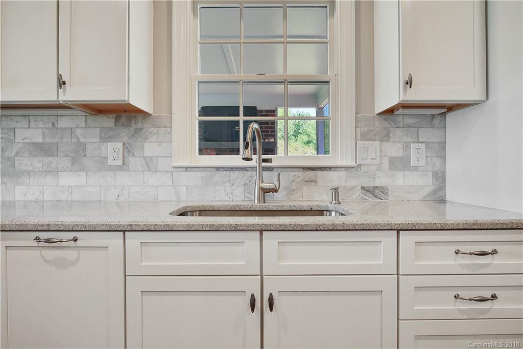 9049 Stacy Howie Road Indian Land, SC 29707 - Photo 12 of 36 a kitchen with granite countertop a sink and cabinets