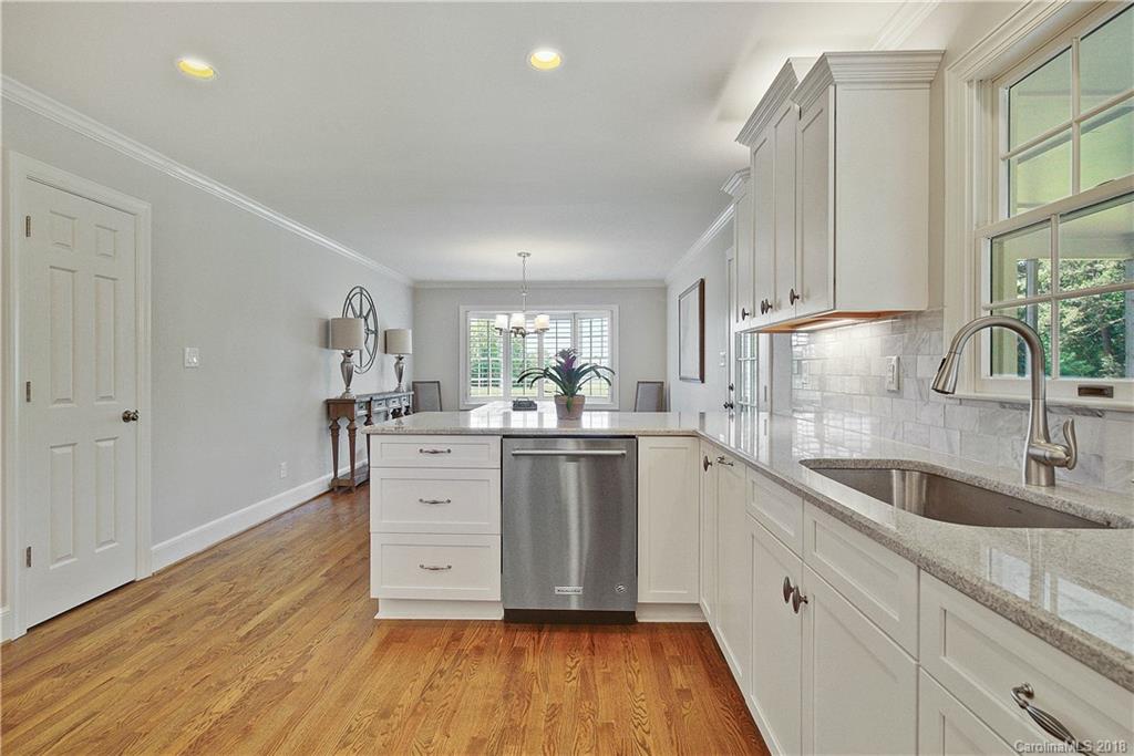 9049 Stacy Howie Road Indian Land, SC 29707 - Photo 13 of 36 a kitchen with sink cabinets and wooden floor
