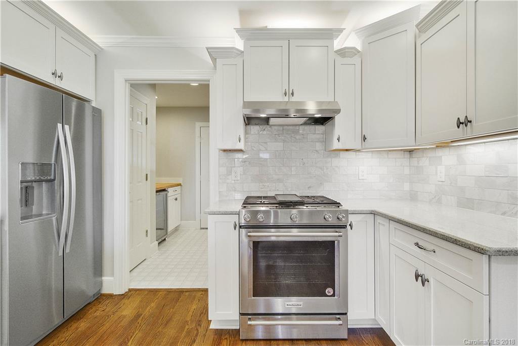 9049 Stacy Howie Road Indian Land, SC 29707 - Photo 16 of 36 a kitchen with stainless steel appliances granite countertop a stove a refrigerator and a sink