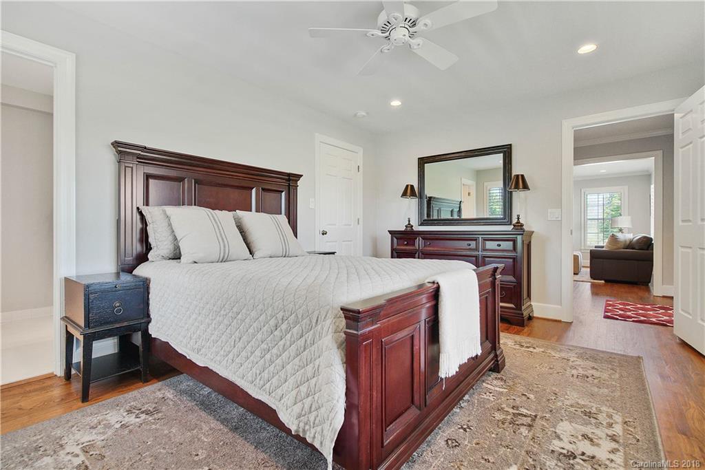 9049 Stacy Howie Road Indian Land, SC 29707 - Photo 21 of 36 a bedroom with a bed and a mirror on dresser