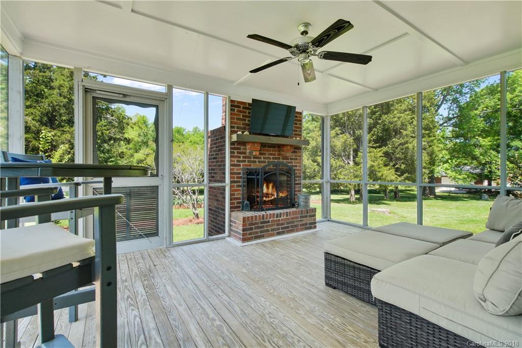 9049 Stacy Howie Road Indian Land, SC 29707 - Photo 30 of 36 a living room with fireplace furniture and a large window