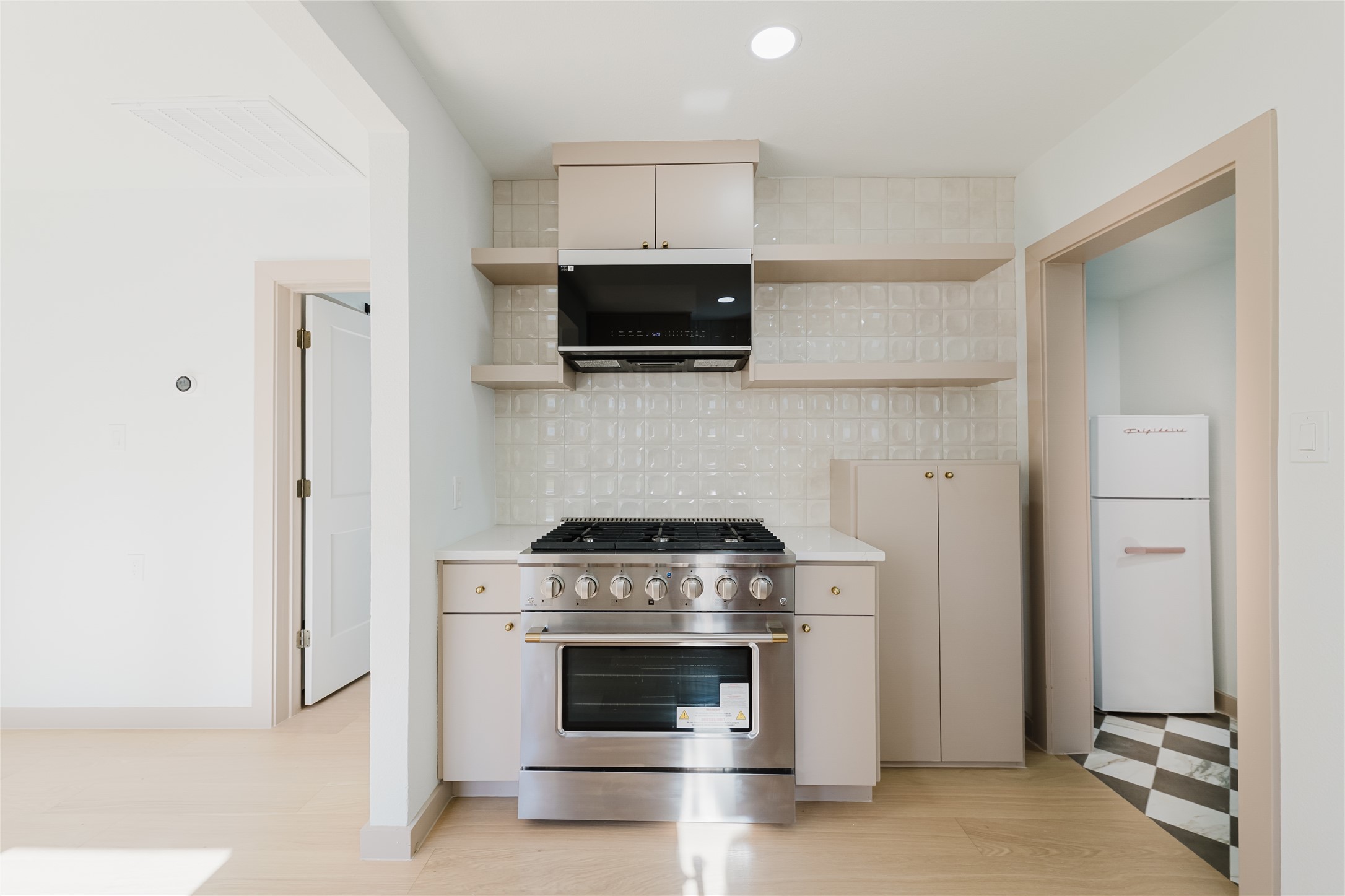 1907 East 21st Street Austin, TX 78722 - Photo 11 of 31 Kitchen featuring gas range, open shelves