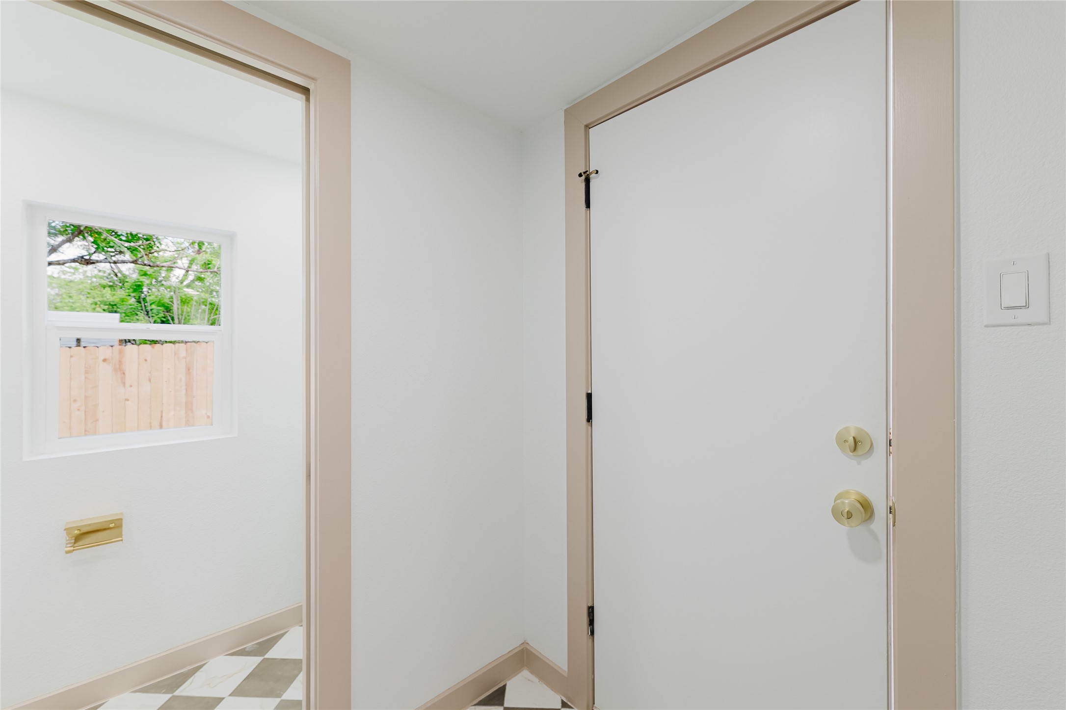 1907 East 21st Street Austin, TX 78722 - Photo 15 of 31 Back Doorway featuring tile patterned floors and baseboards