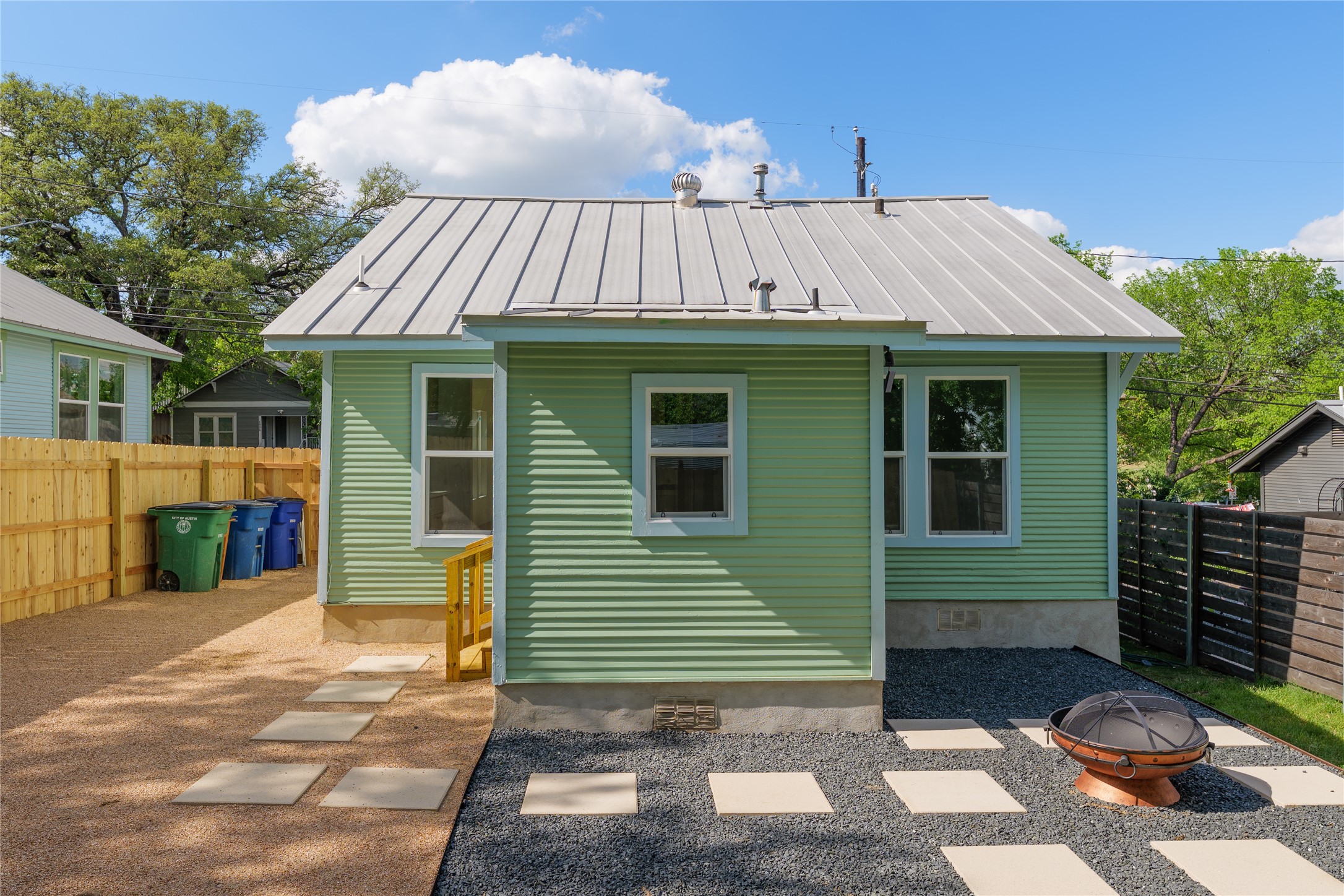 1907 East 21st Street Austin, TX 78722 - Photo 28 of 31 Back of house with a fenced backyard, and fire pit.