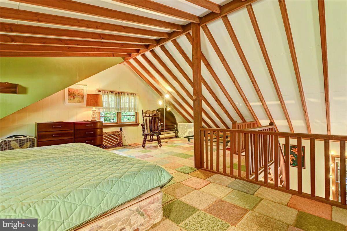 112 Beechwood Cove Road Greentown, PA 18426 - Photo 27 of 59 a spacious bedroom with a bed and a chandelier