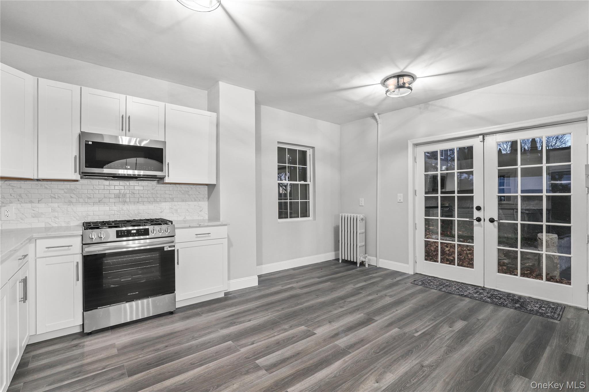 350 Commerce Street Hawthorne, NY 10532 - Photo 11 of 22 a view of kitchen with kitchen island wooden floor appliances and cabinets
