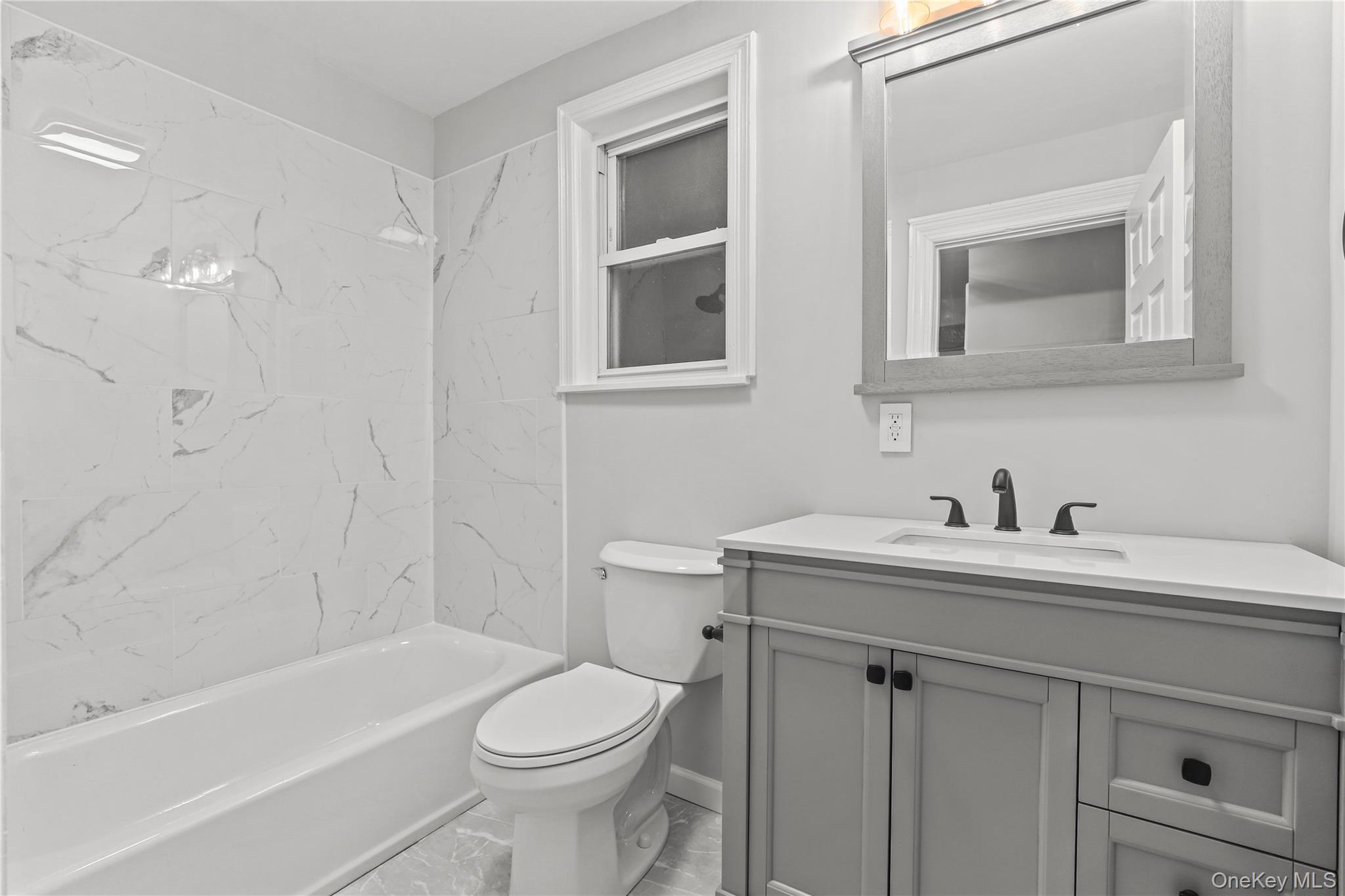 350 Commerce Street Hawthorne, NY 10532 - Photo 16 of 22 a bathroom with a sink a toilet and shower