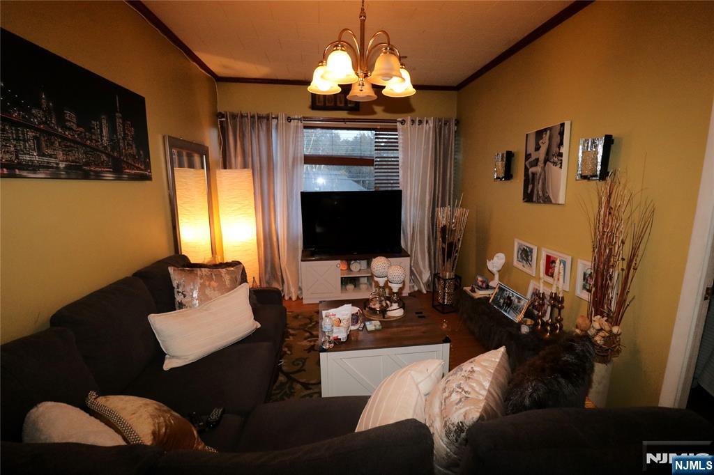 233-235 Adams Street Newark, NJ 07105 - Photo 11 of 20 a living room with furniture and a flat screen tv