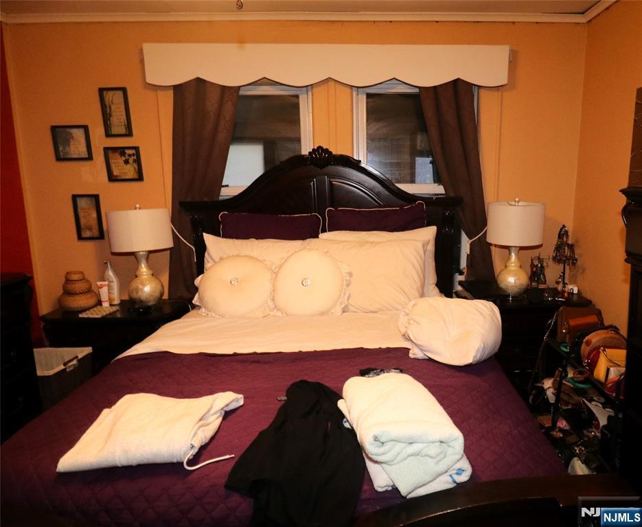 233-235 Adams Street Newark, NJ 07105 - Photo 12 of 20 a bedroom with a bed and a painting on the wall