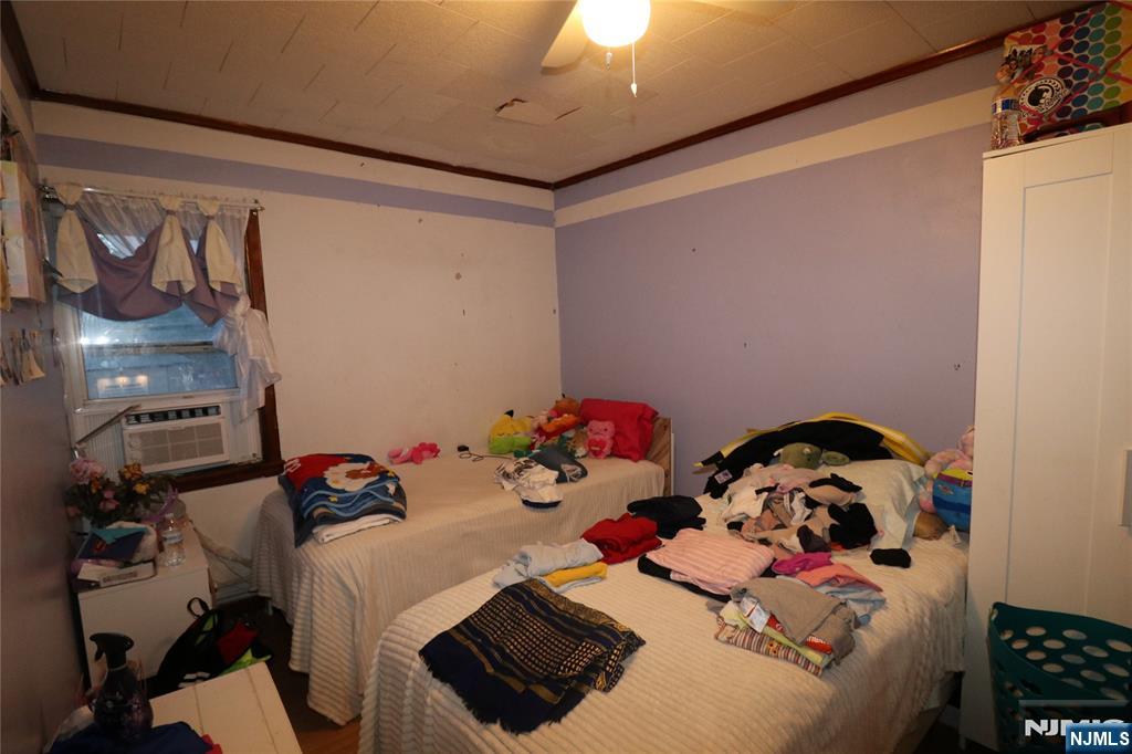 233-235 Adams Street Newark, NJ 07105 - Photo 13 of 20 a bedroom with a bed and a tv