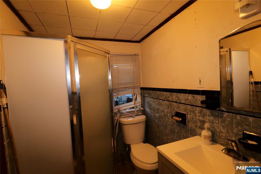 233-235 Adams Street Newark, NJ 07105 - Photo 14 of 20 a bathroom with a toilet and a shower