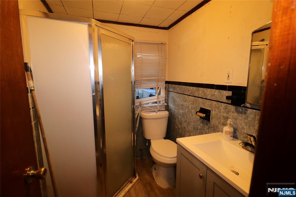233-235 Adams Street Newark, NJ 07105 - Photo 15 of 20 a bathroom with a sink and a toilet