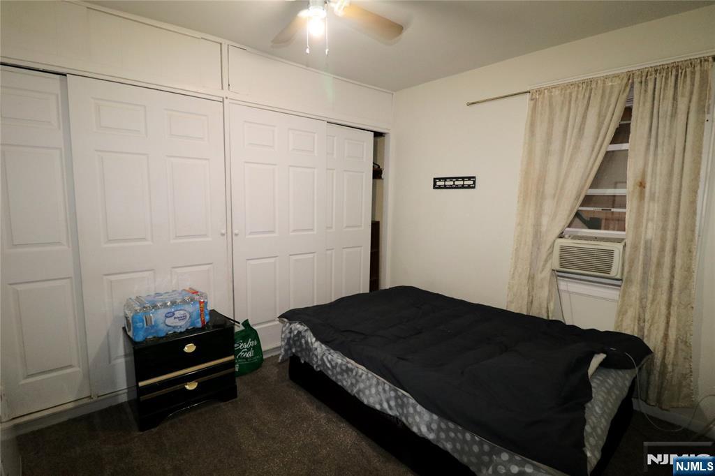 233-235 Adams Street Newark, NJ 07105 - Photo 3 of 20 a bedroom with a bed and a window