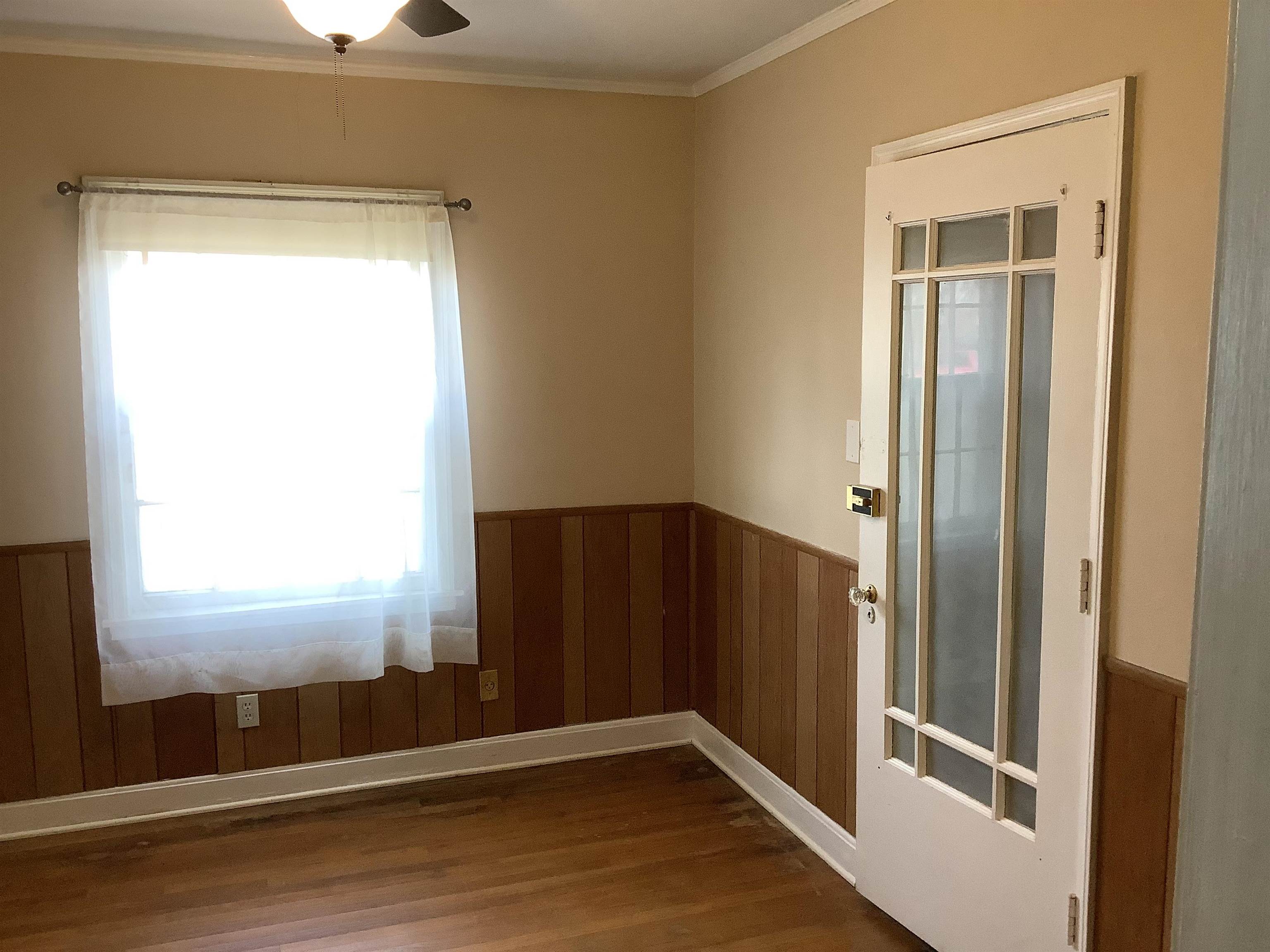 4153 Lawrence Road Memphis, TN 38122 - Photo 4 of 13 a view of empty room with wooden floor and fan