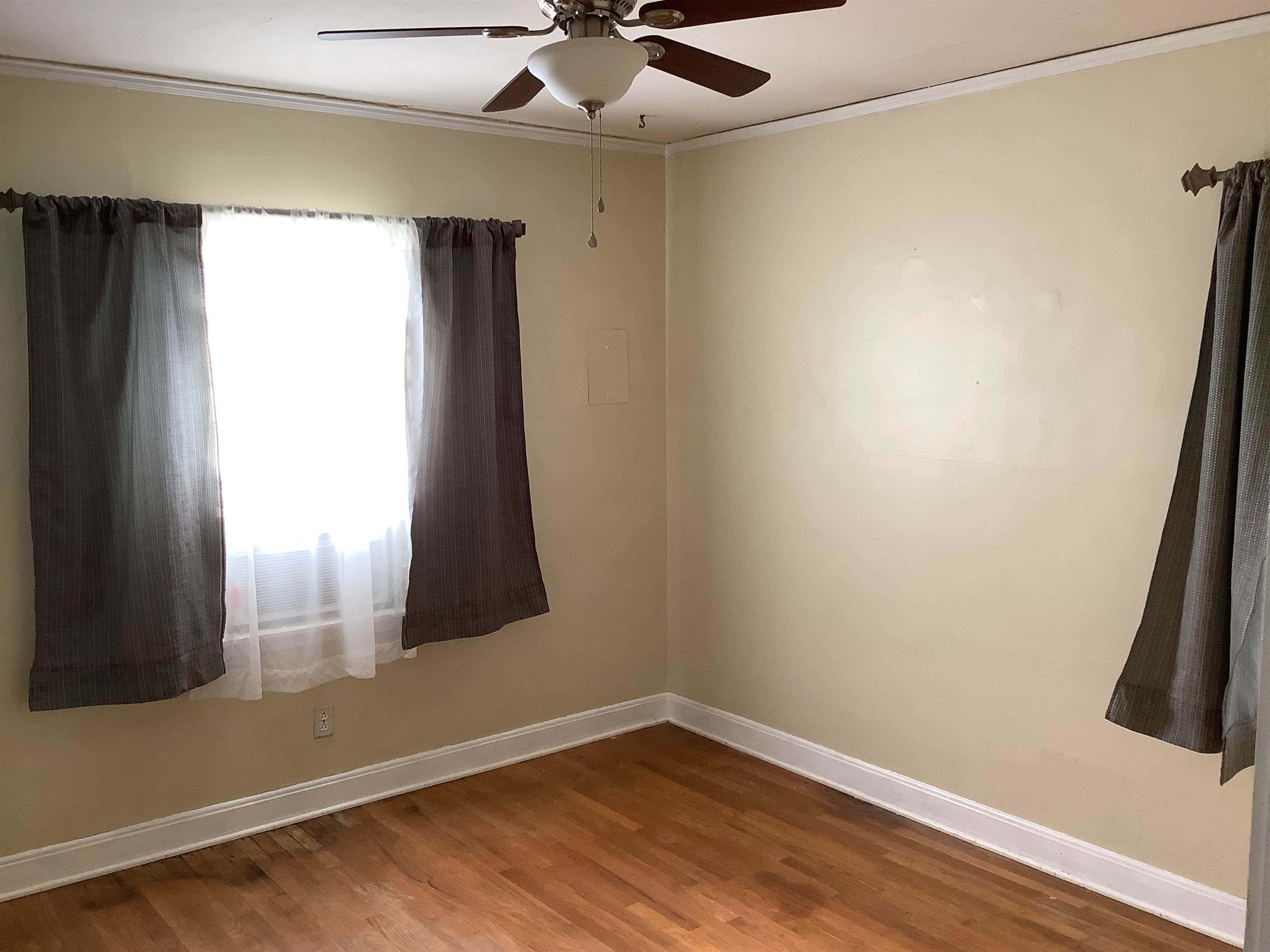 4153 Lawrence Road Memphis, TN 38122 - Photo 8 of 13 a view of empty room with wooden floor and fan