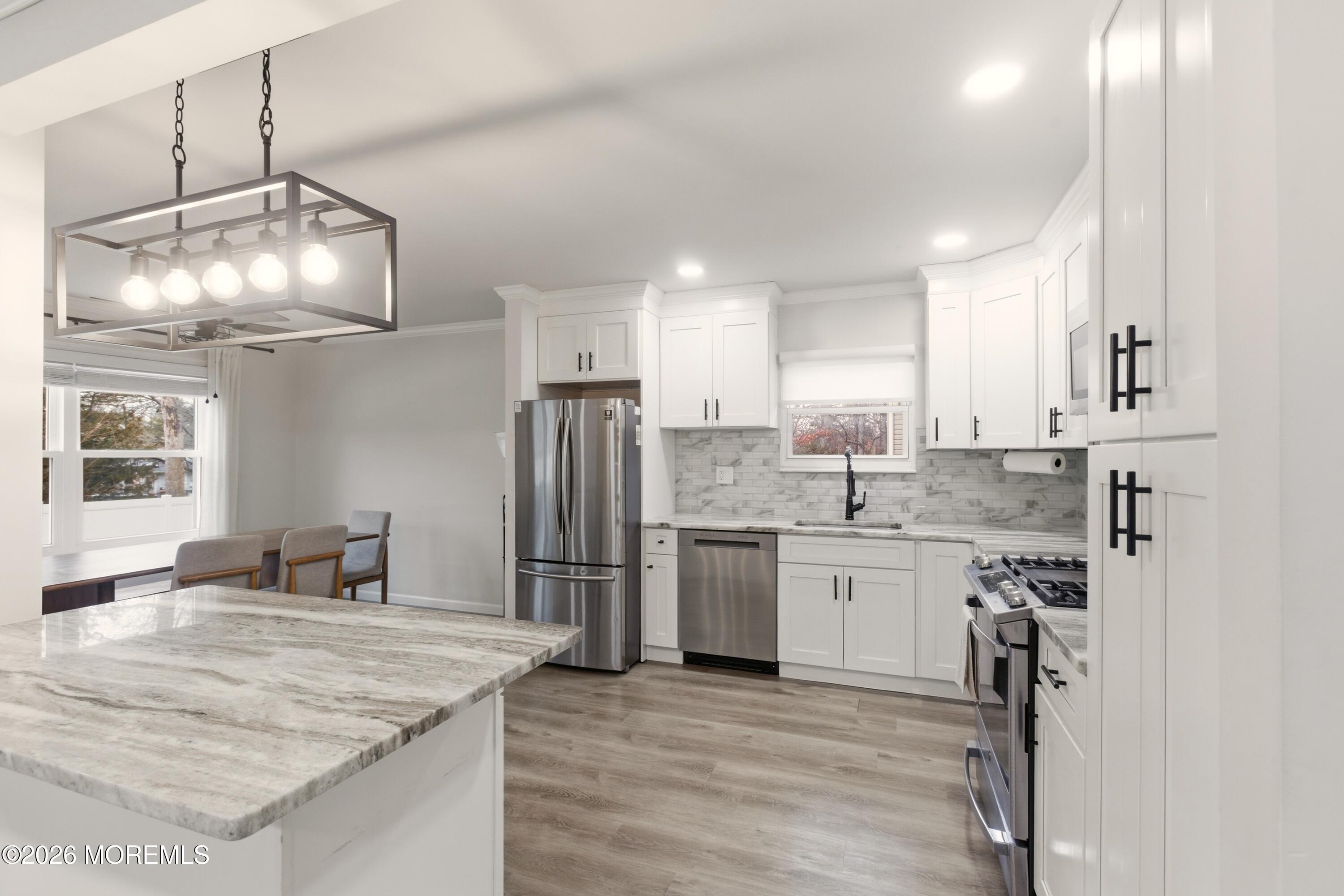 19 Silversmith Court Howell, NJ 07731 - Photo 20 of 48 a kitchen with stainless steel appliances granite countertop a sink refrigerator and cabinets