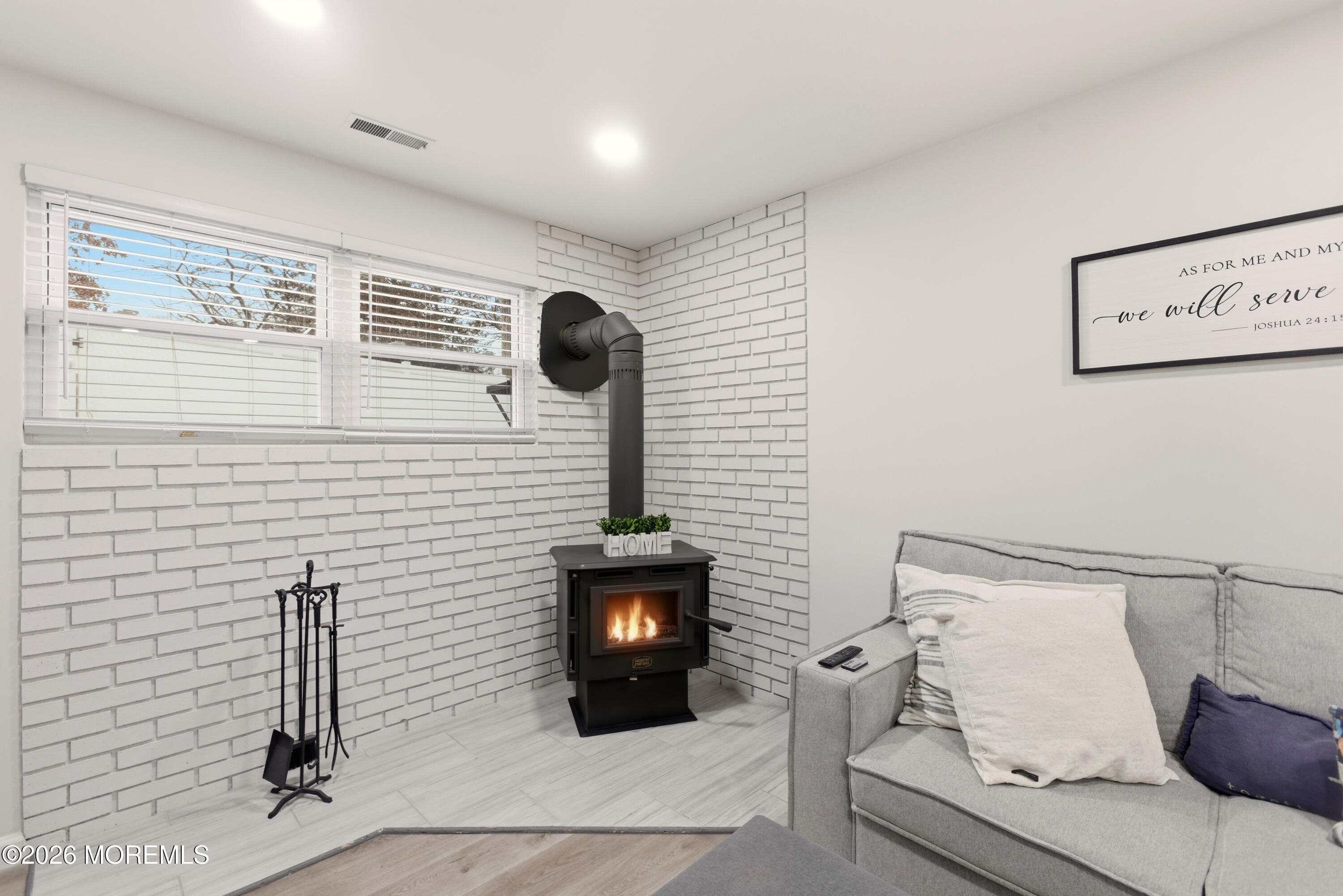 19 Silversmith Court Howell, NJ 07731 - Photo 22 of 48 a hallway with a couch and a fireplace