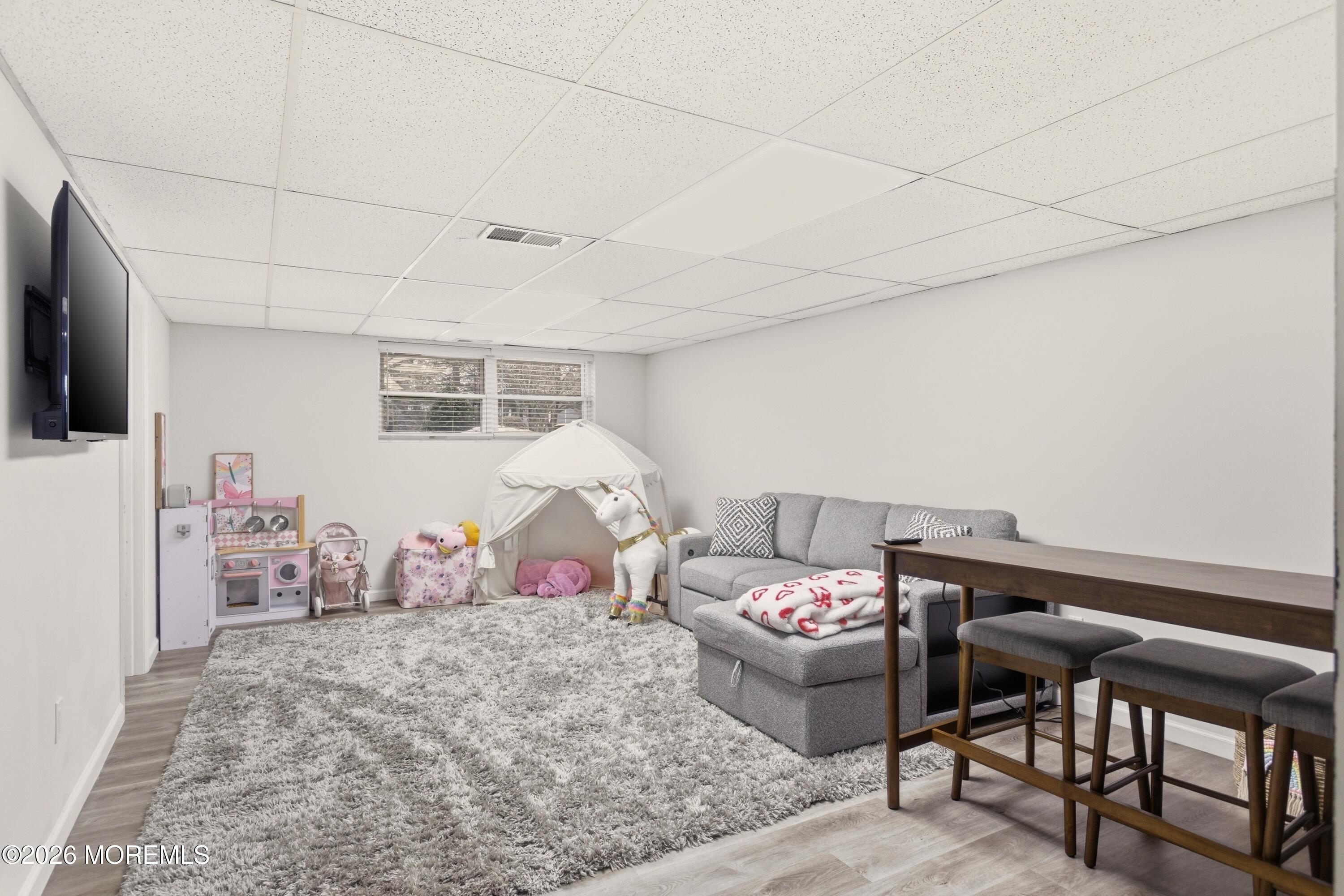 19 Silversmith Court Howell, NJ 07731 - Photo 25 of 48 a bedroom with furniture and a flat screen tv