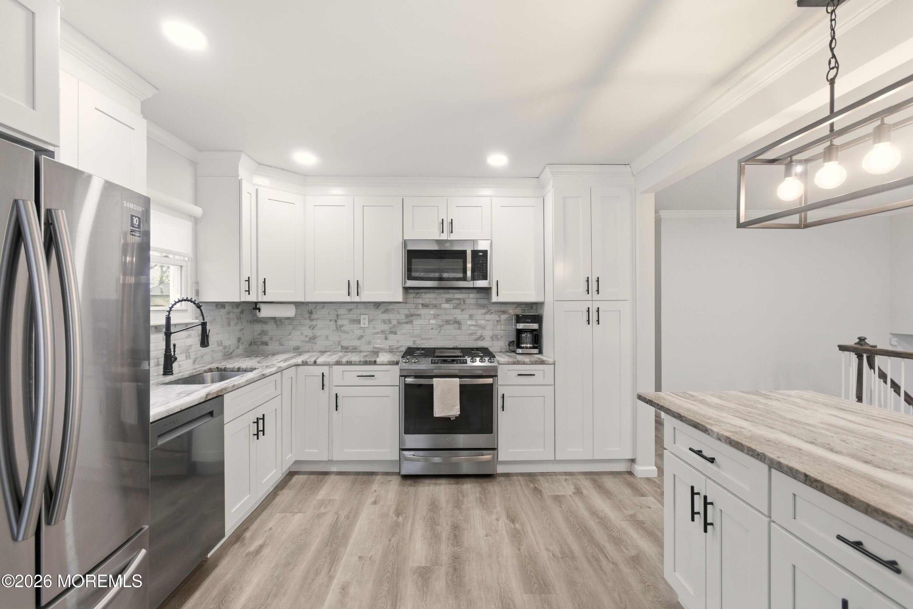 19 Silversmith Court Howell, NJ 07731 - Photo 8 of 48 a kitchen with stainless steel appliances granite countertop a refrigerator sink and stove