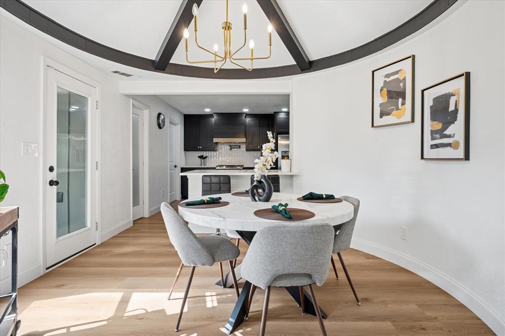 6030 Blue Mist Lane Dallas, TX 75248 - Photo 11 of 29 a dining room with furniture a chandelier and wooden floor