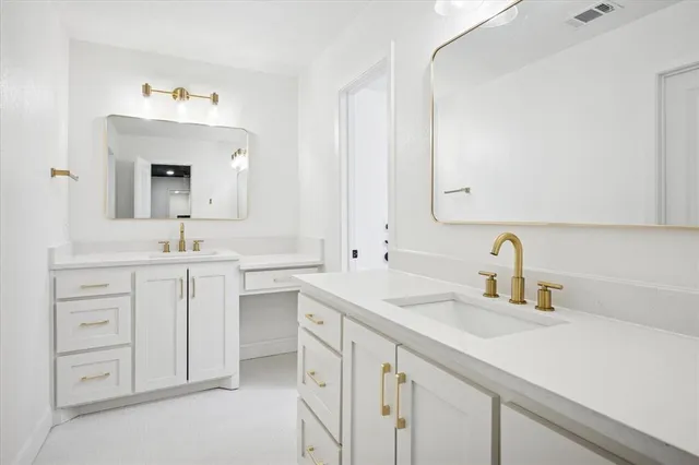 a bathroom with a sink double vanity and a mirror