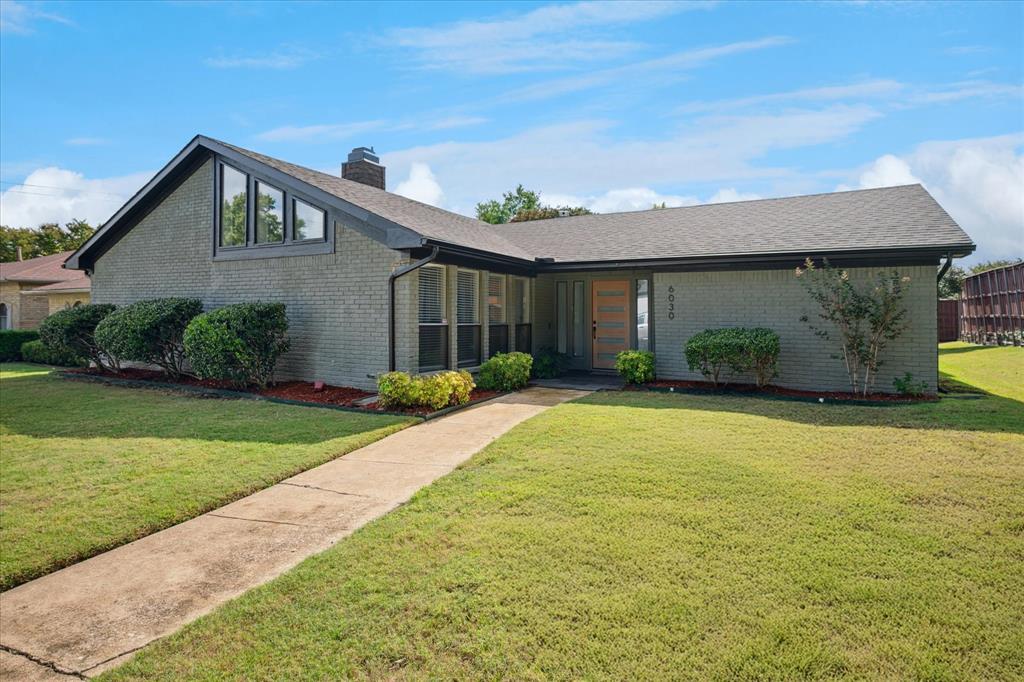 6030 Blue Mist Lane Dallas, TX 75248 - Photo 2 of 29 a front view of a house with garden