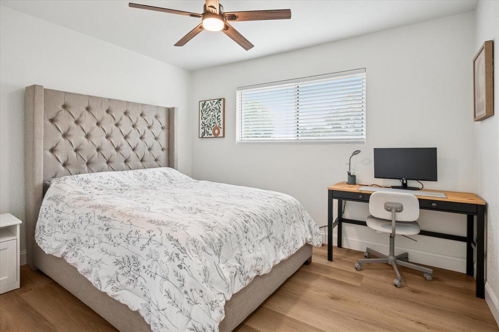 6030 Blue Mist Lane Dallas, TX 75248 - Photo 21 of 29 a bedroom with a bed and a flat screen tv