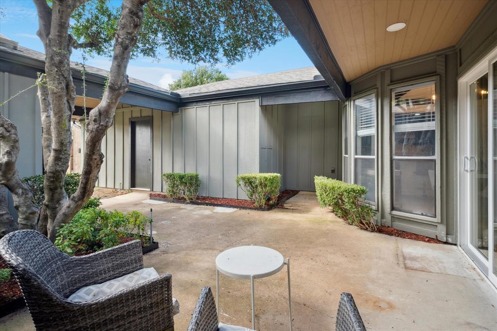 6030 Blue Mist Lane Dallas, TX 75248 - Photo 26 of 29 a view of a chair and table in backyard of the house