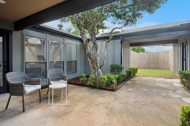 a backyard of a house with table and chairs