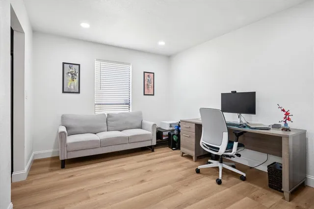 a livingroom with workspace and a couch