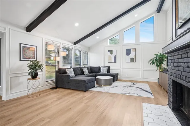 a living room with fireplace furniture and a fireplace