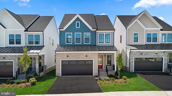 43290 Greeley Square Ashburn, VA 20148 - Photo 1 of 39 a front view of a house with a yard and garage