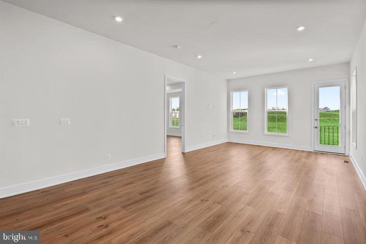 43290 Greeley Square Ashburn, VA 20148 - Photo 11 of 39 a view of an empty room with wooden floor and a window