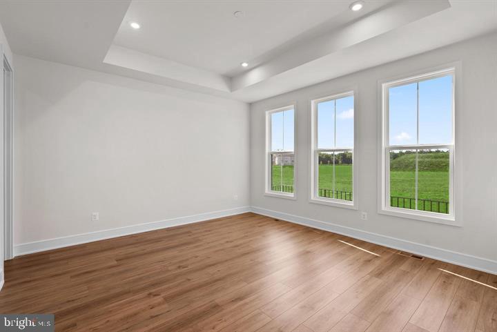 43290 Greeley Square Ashburn, VA 20148 - Photo 12 of 39 a view of an empty room with wooden floor and a window
