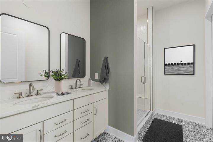 43290 Greeley Square Ashburn, VA 20148 - Photo 16 of 39 a bathroom with double sink and a mirror