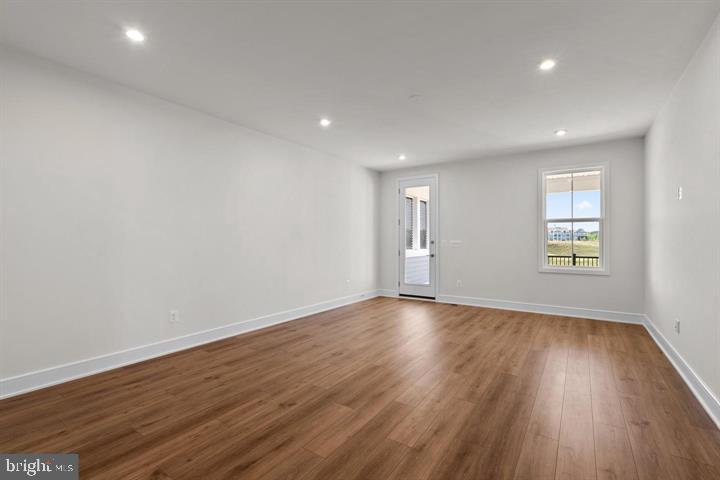 43290 Greeley Square Ashburn, VA 20148 - Photo 19 of 39 a view of an empty room with wooden floor and a window