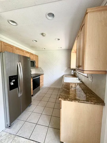 a kitchen with stainless steel appliances a refrigerator and a stove