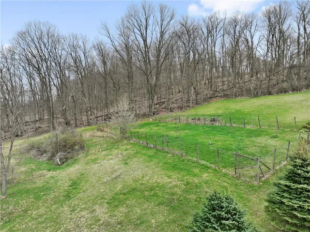 a view of a house with backyard sitting area and garden
