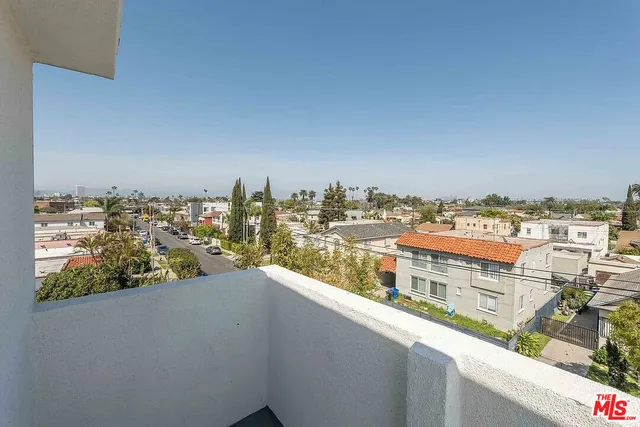 a view of room with wooden floor and white walls