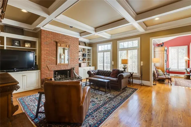 a living room with fireplace furniture and a flat screen tv