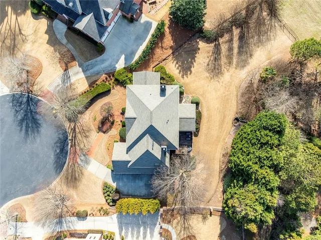 an aerial view of a house with a yard and garden