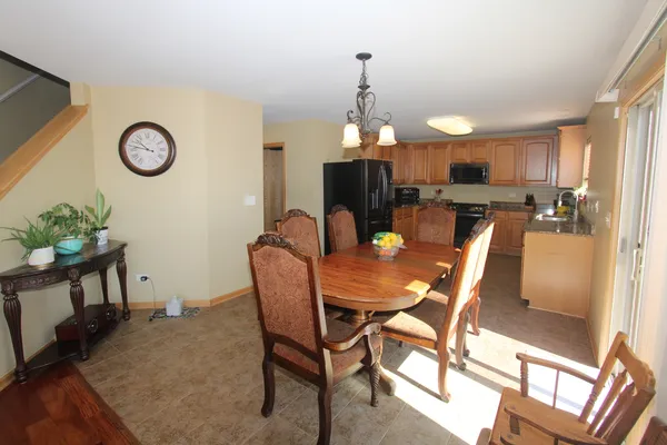 a view of a dining room with furniture and a chandelier